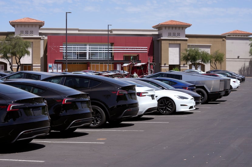 Tesla vehicles are stored at a shopping mall parking lot near a closed movie theater Friday,...