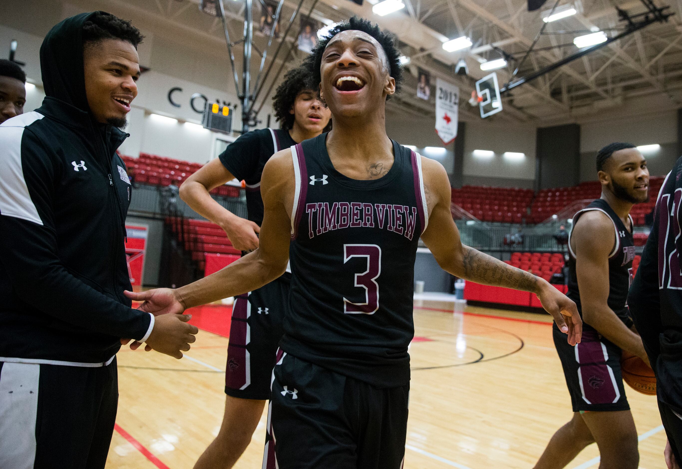 Mansfield Timberview guard Davontae McKinney (3) and other players celebrate a 40-36 win...