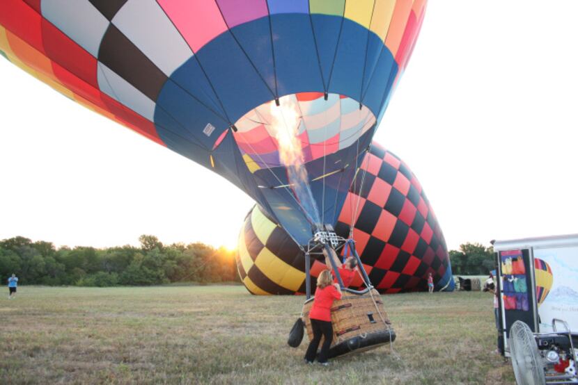 Luc and Loren Goethals finish inflating "Zipper," their hot air balloon. Luc took two...