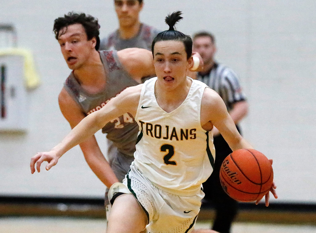 Newman Smith High School guard Thibaut Tagnon (2) brings the ball down the floor in from of...