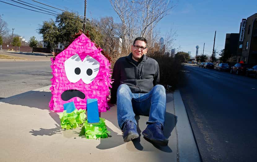 Dallas artist Giovanni Valderas with one of his "sad house" piñatas in 2018. He displays his...