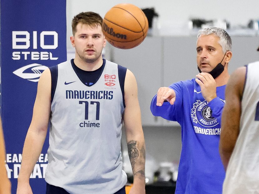 Dallas Mavericks guard Luka Doncic (77) listens to assistant coach Igor Kokoskov during a...