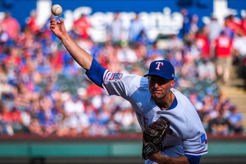 Texas Rangers starting pitcher Kyle Dowdy throws during the seventh inning against the...