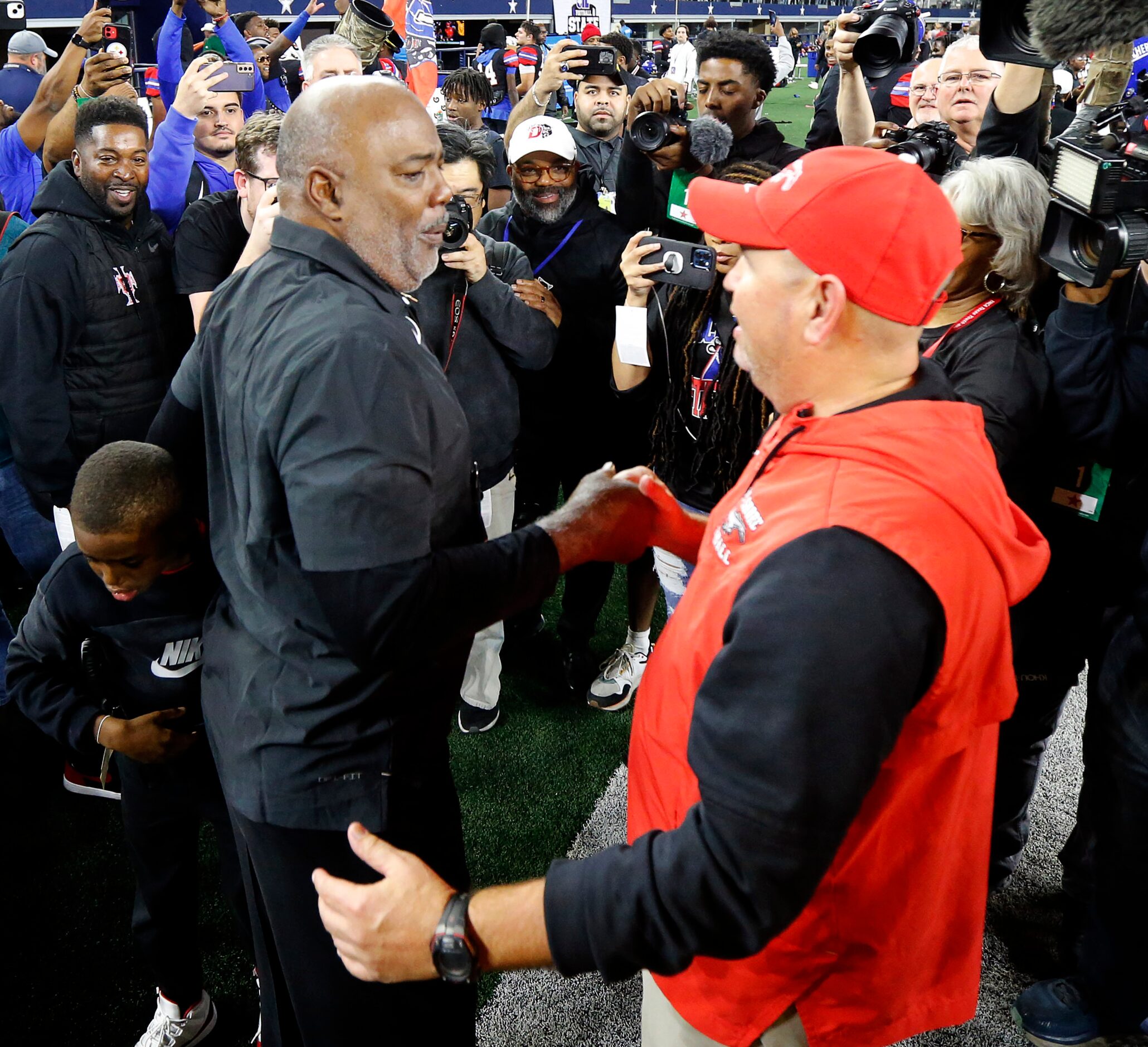 Duncanville head coach Reginald Samples (left) is congratulated by Galena Park North Shore...