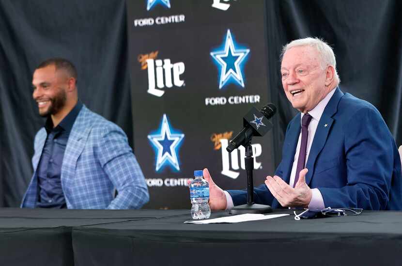 Dallas Cowboys owner Jerry Jones speaks about the signing of quarterback Dak Prescott (left)...