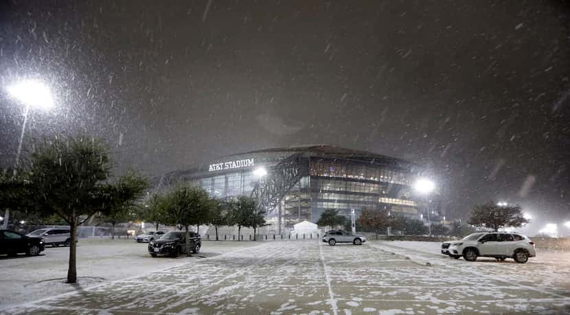 Light snow falls outside AT&T Stadium following the Dallas Cowboys Wild Card Playoff loss to...