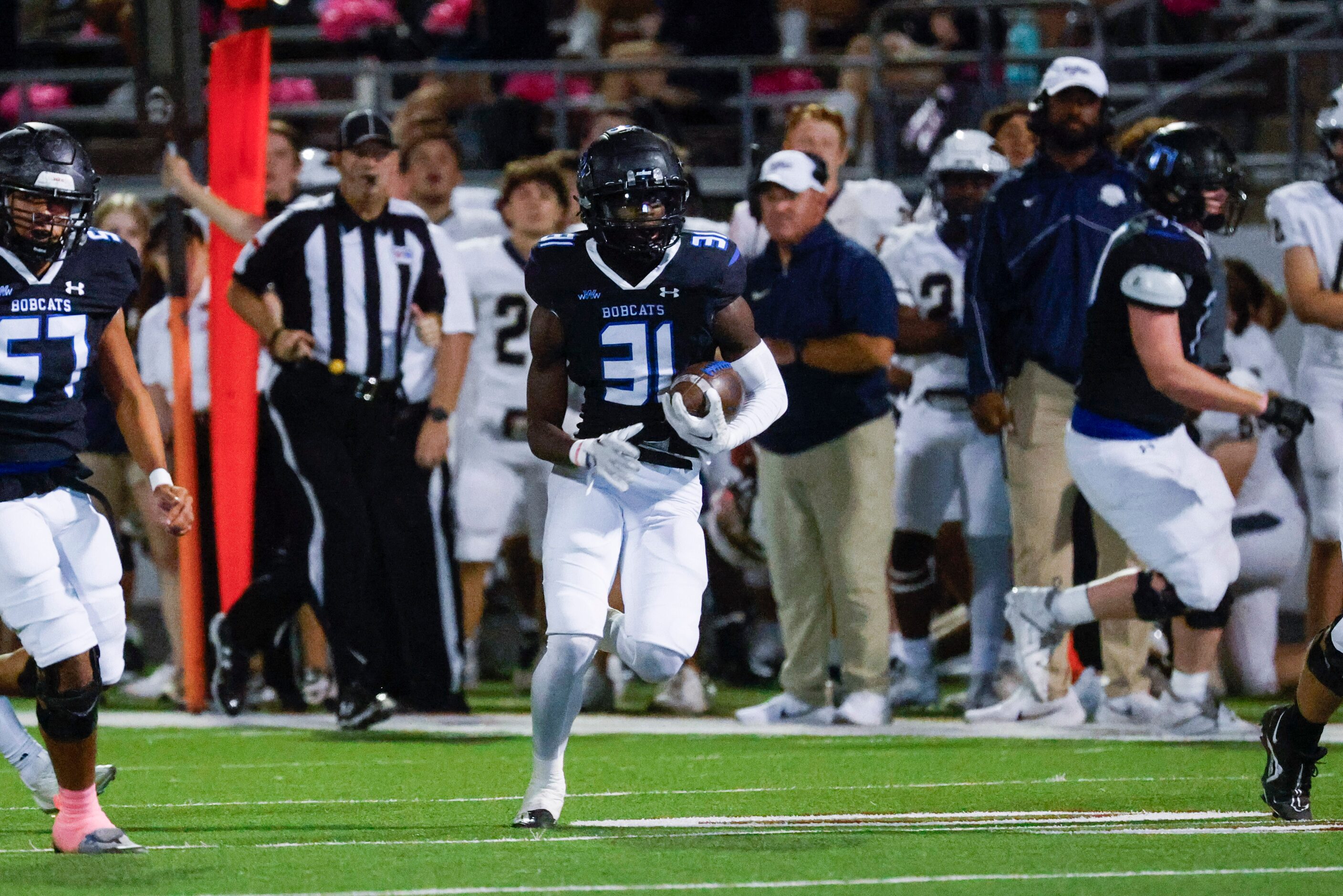 Byron Nelson high’s Manny Mumba (31) runs with the ball during the second half of a football...