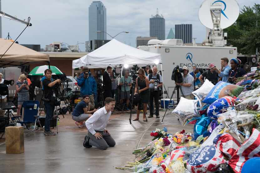 Media crews capture mourners in downtown Dallas on July 10