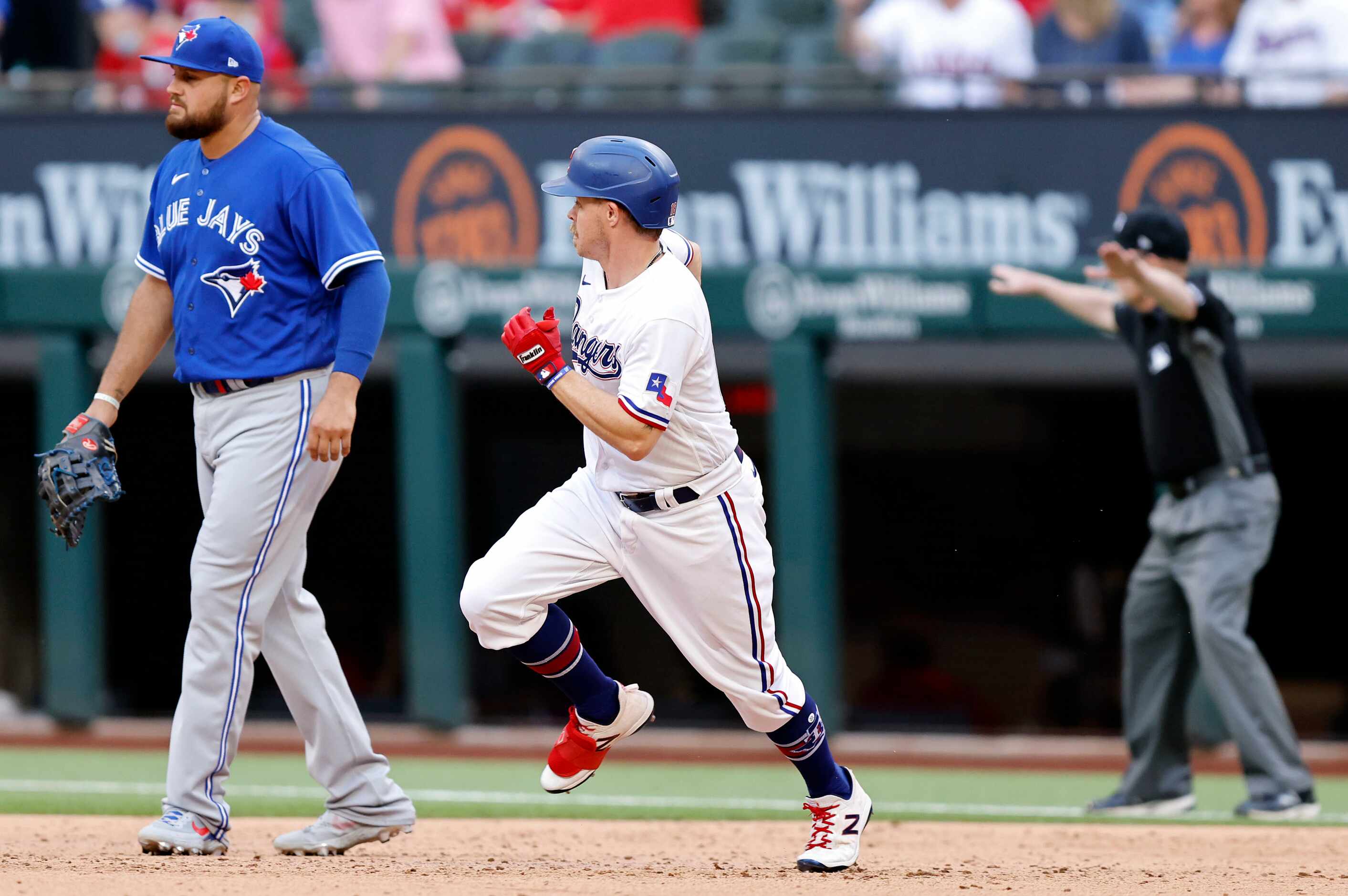 Texas Rangers second baseman Brock Holt (16) turns first on an RBI double in ninth inning...