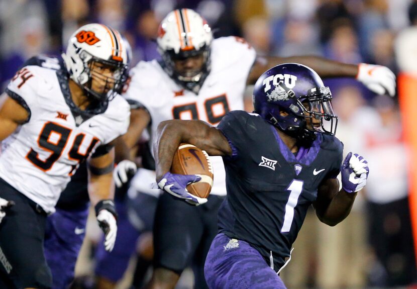 FILE - TCU Horned Frogs wide receiver Jalen Reagor (1) races around the end for a long third...