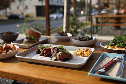 Loro's smoked baby back Duroc pork ribs sit front and center in a spread of the restaurant's...