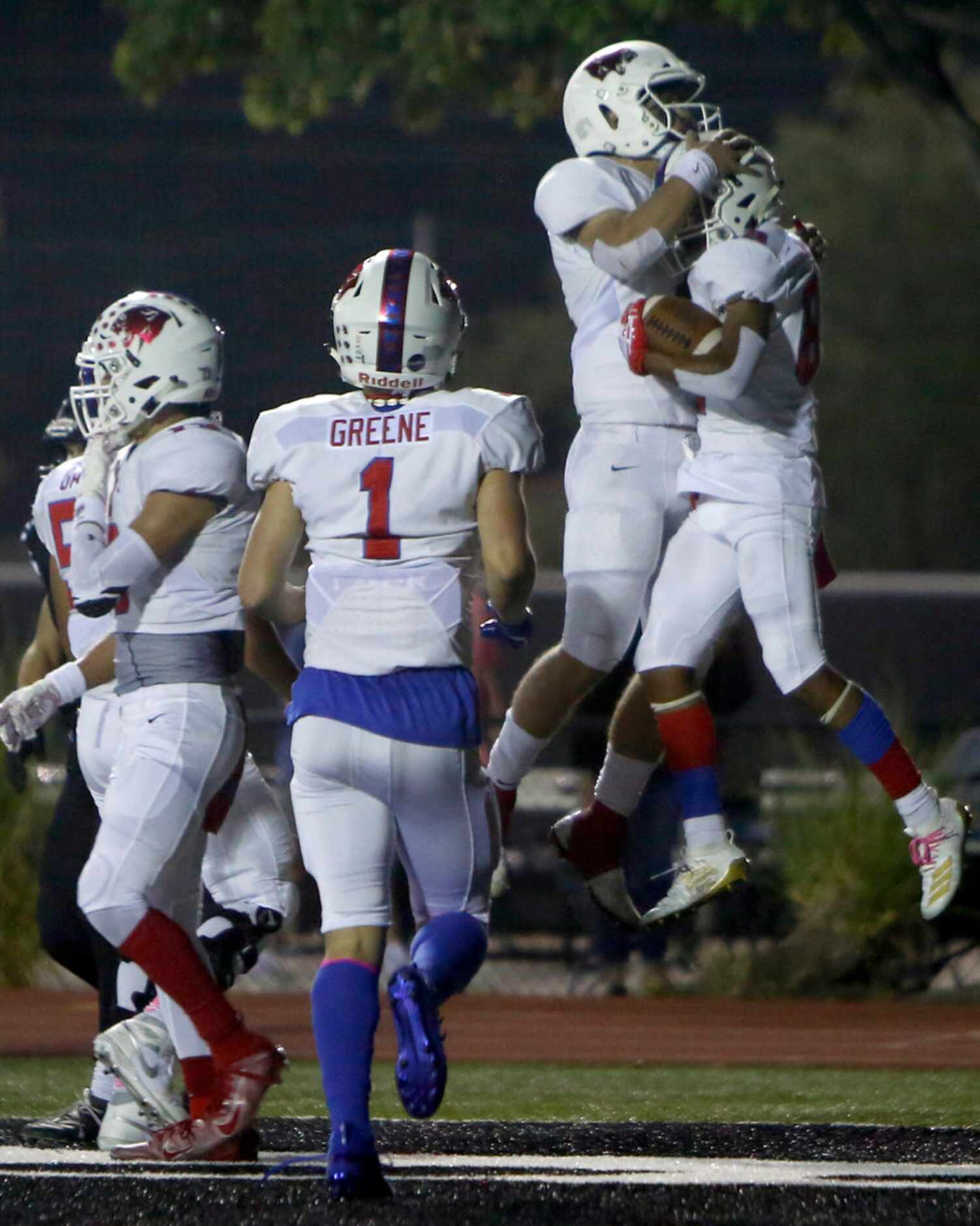 Parish Episcopal receiver Jai Moore (89), right, is congratulated by quarterback Preston...