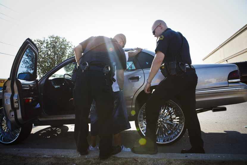 Dallas Police Officers Bryan Burgess and Lance Wreyford arrest a man for outstanding...