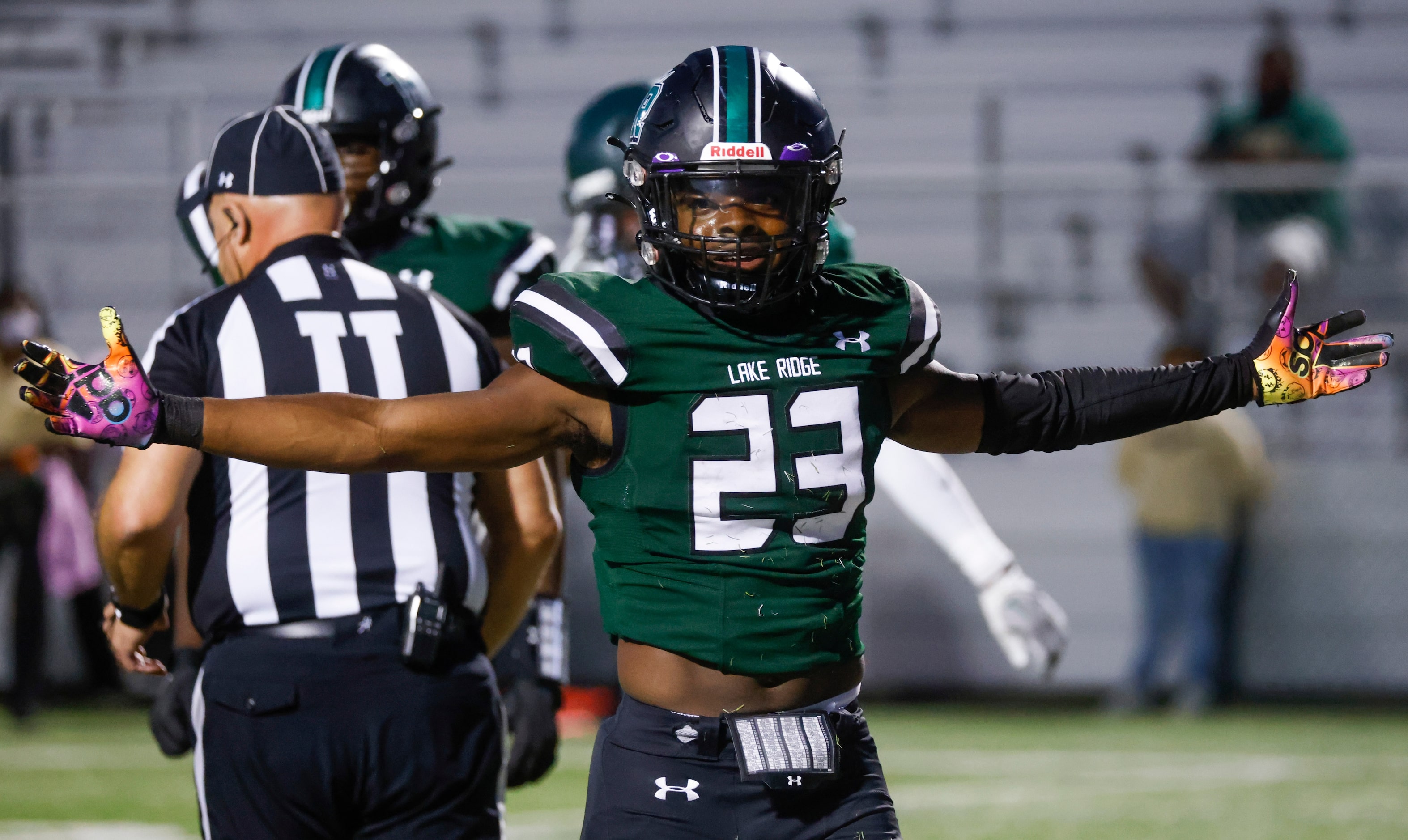 Lake Ridge High School’s Raycine Guilty (23) celebrates a touchdown against DeSoto High...