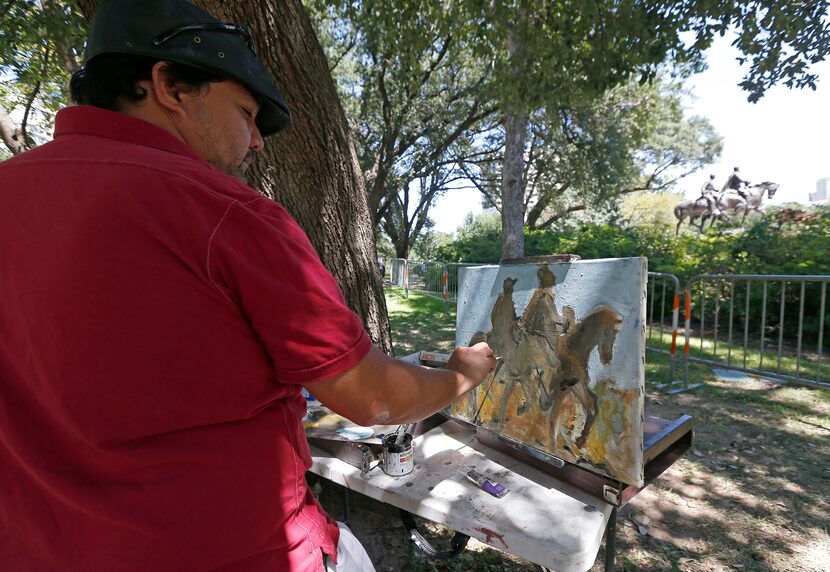 Artist Jerrel Sustaita works on his painting of the Robert E. Lee statue at Robert E. Lee...