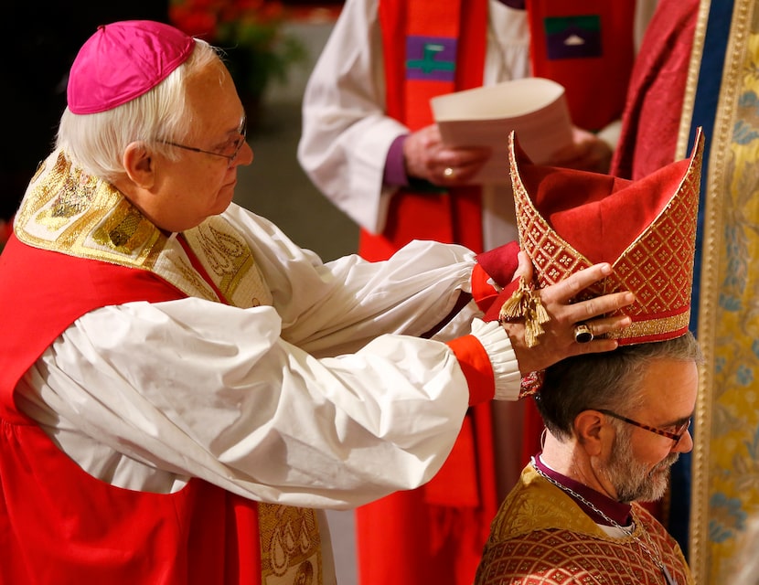 Retired Bishop James Stanton, left, places a mitre on Bishop-elect George R. Sumner during a...