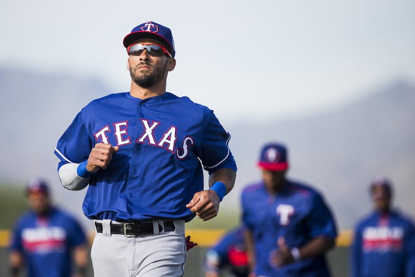 Texas Rangers outfielder Ian Desmond runs with teammates during a spring workout at the...