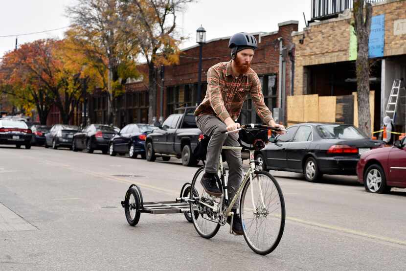 Mark Draz, 29, a library associate at the downtown Dallas branch, rides a prototype model of...