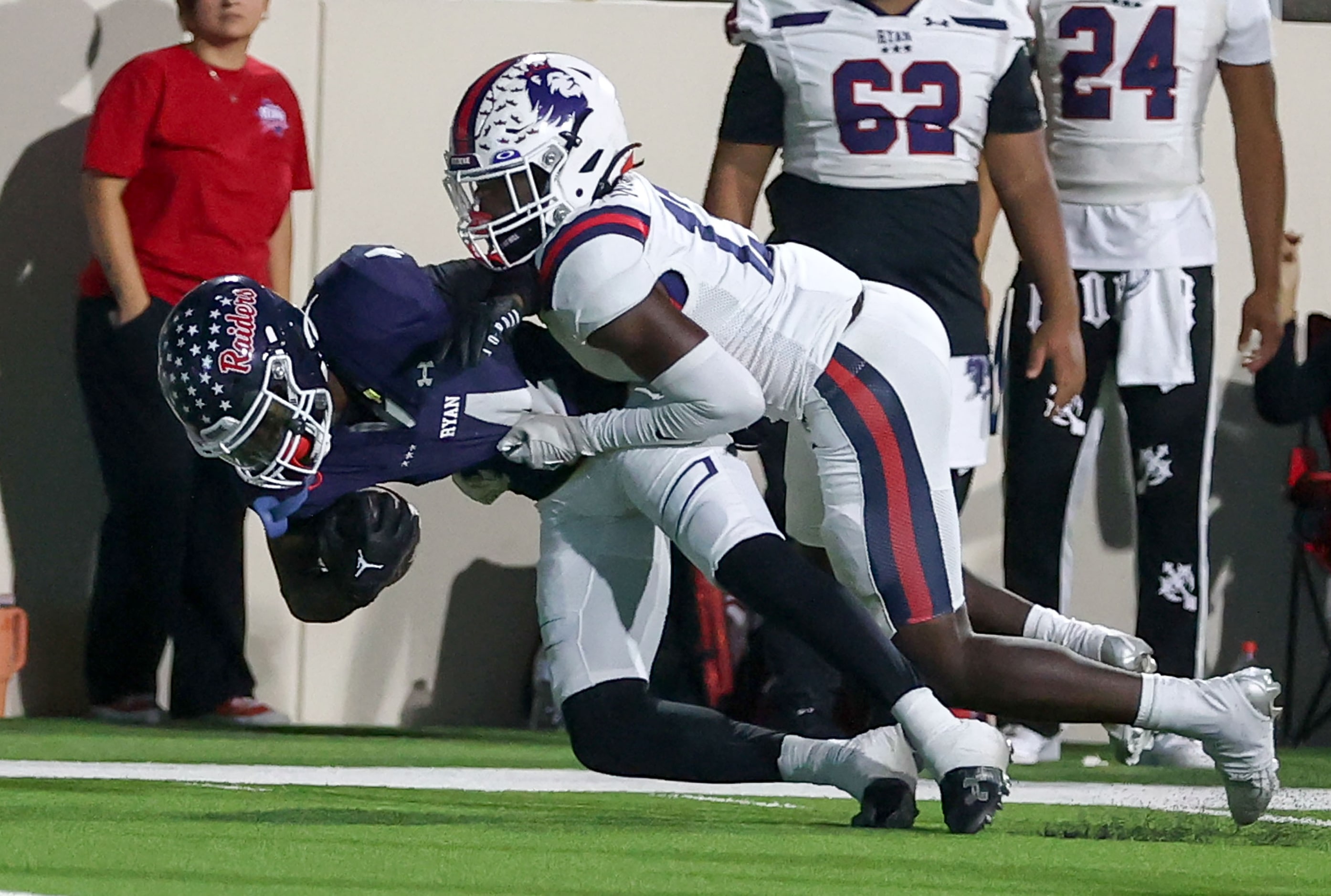 Denton Ryan running back Tre'Vaughn Reynolds (4) is brought down short of the goalline by...