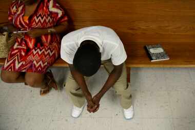 
A boy from the Diversion Male Court waits with his mother to speak with Judge George...