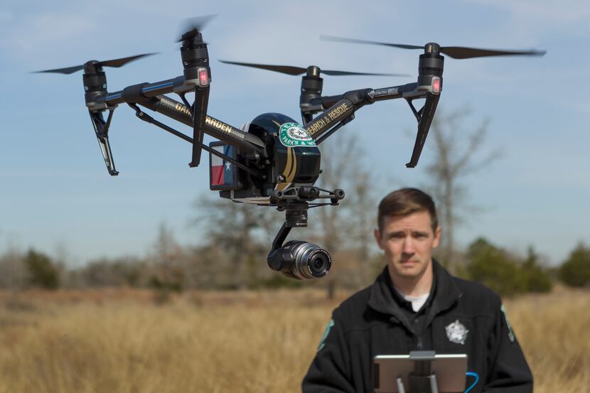 An official with the Texas Parks and Wildlife Department operates the department's new drone