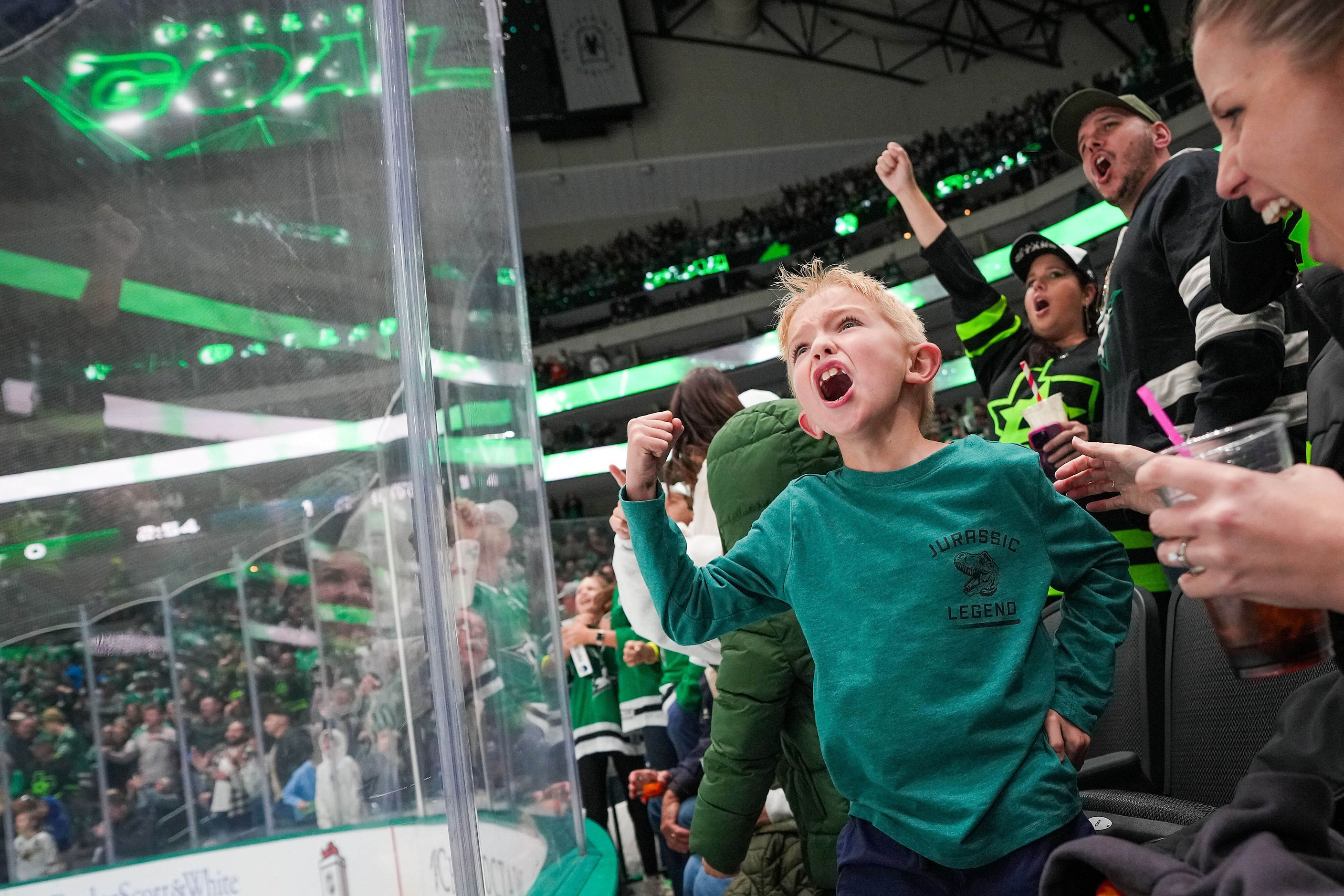 Dallas Stars fan Noah Dovin and his mom Heidi Dovin celebrate a goal by center Wyatt...