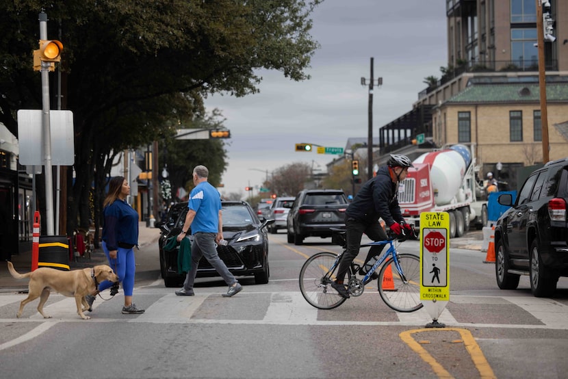 Pedestrians on the Katy Trail cross Knox Street in Dallas on Monday, Dec. 23, 2024. 