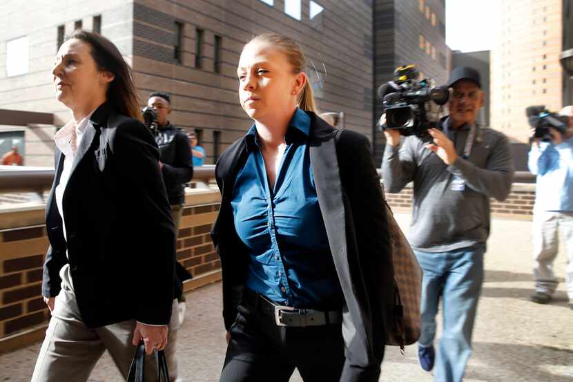 Former Dallas police Officer Amber Guyger (center) leaves the Frank Crowley Courts Building...