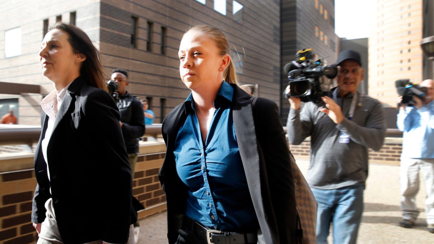 Former Dallas police Officer Amber Guyger (center) leaves the Frank Crowley Courts Building...