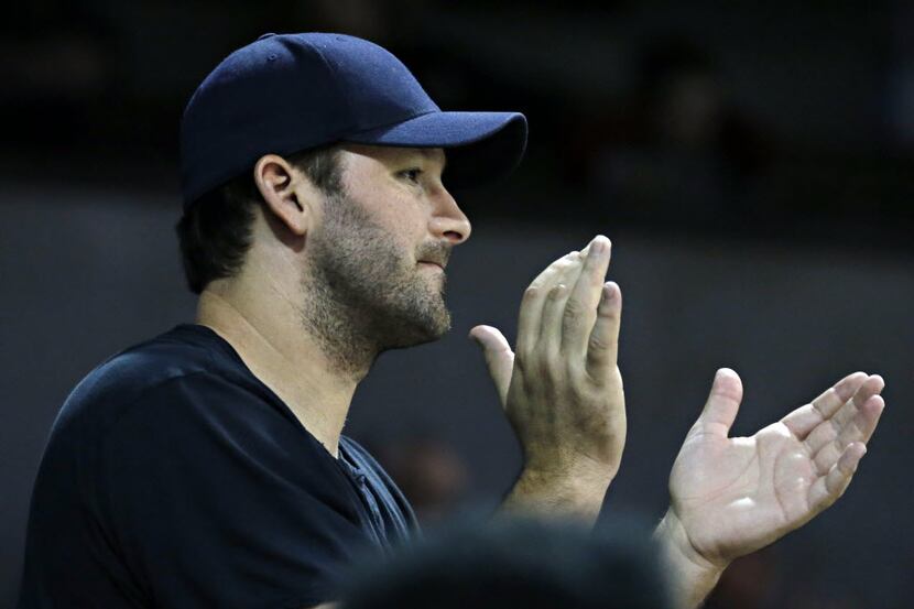 Dallas Cowboys quarterback Tony Romo cheers during the second half of the SMU Mustangs'...