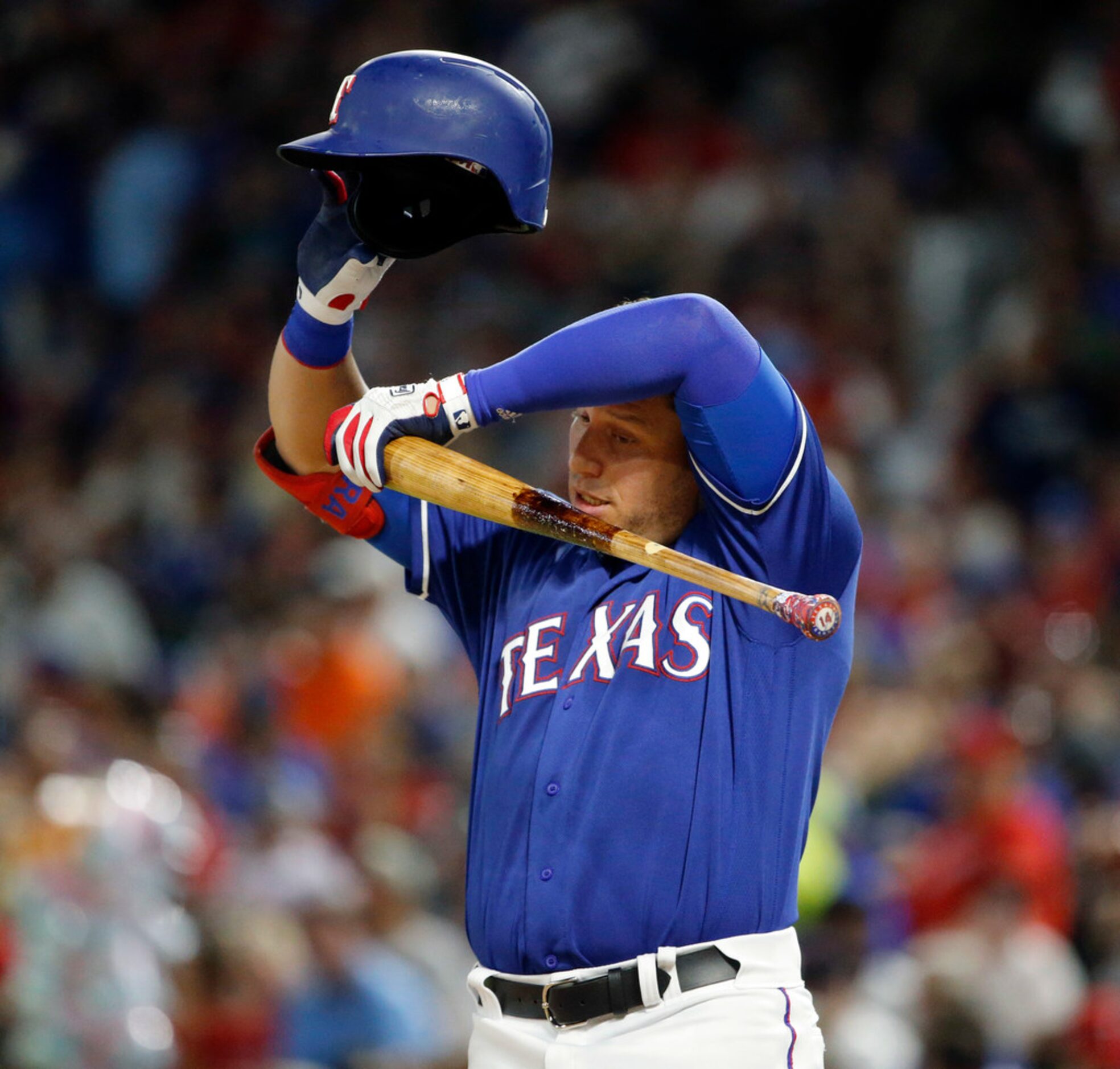 Texas Rangers second baseman Danny Santana (38) wipes away the sweat between pitches during...