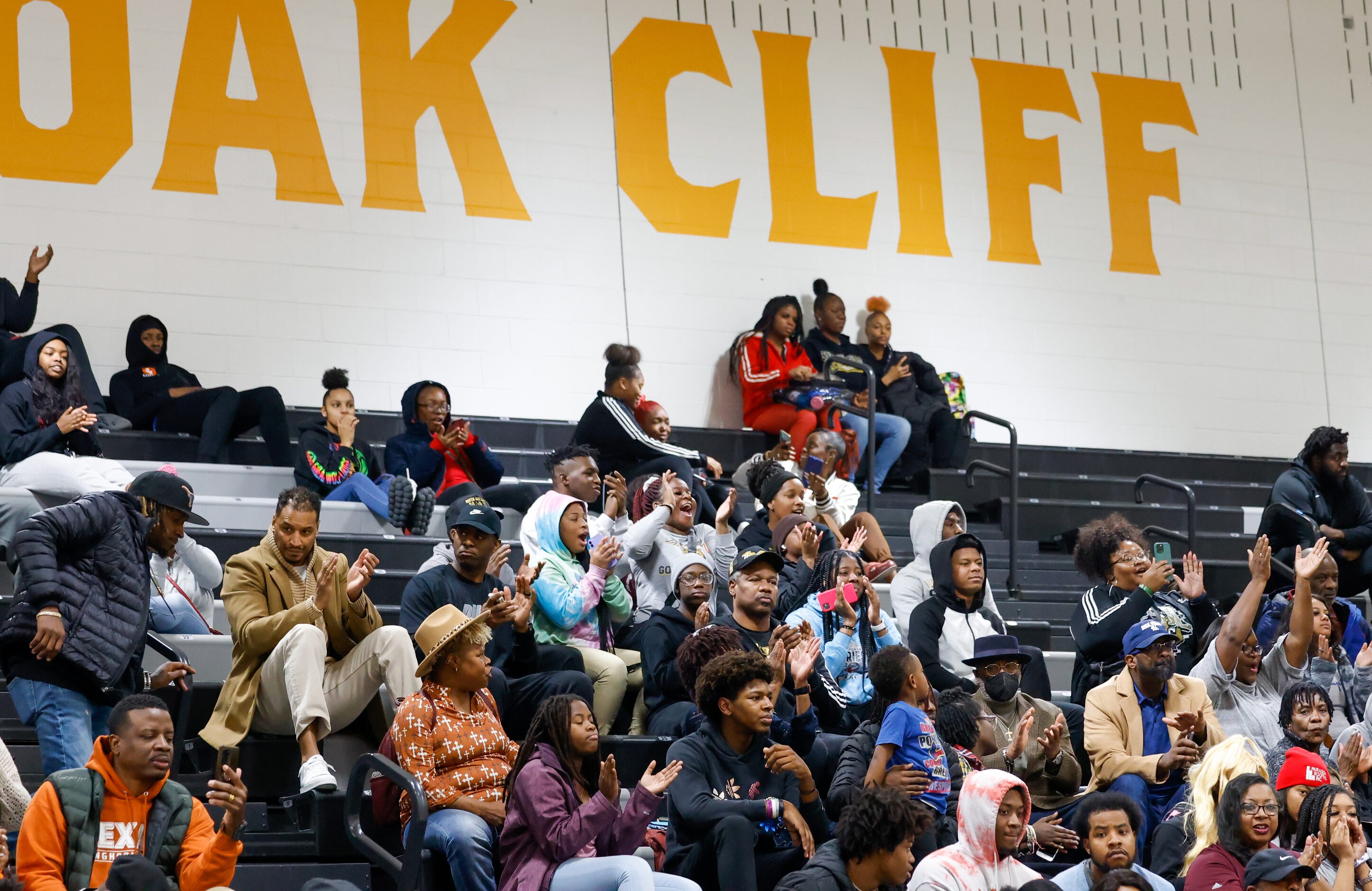 Students, staff, family and friends cheer for South Oak Cliff football players during a...