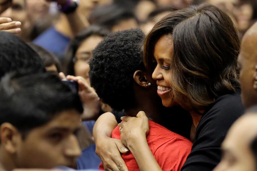 First lady Michelle Obama hugs a high school student during College Signing Day, an annual...
