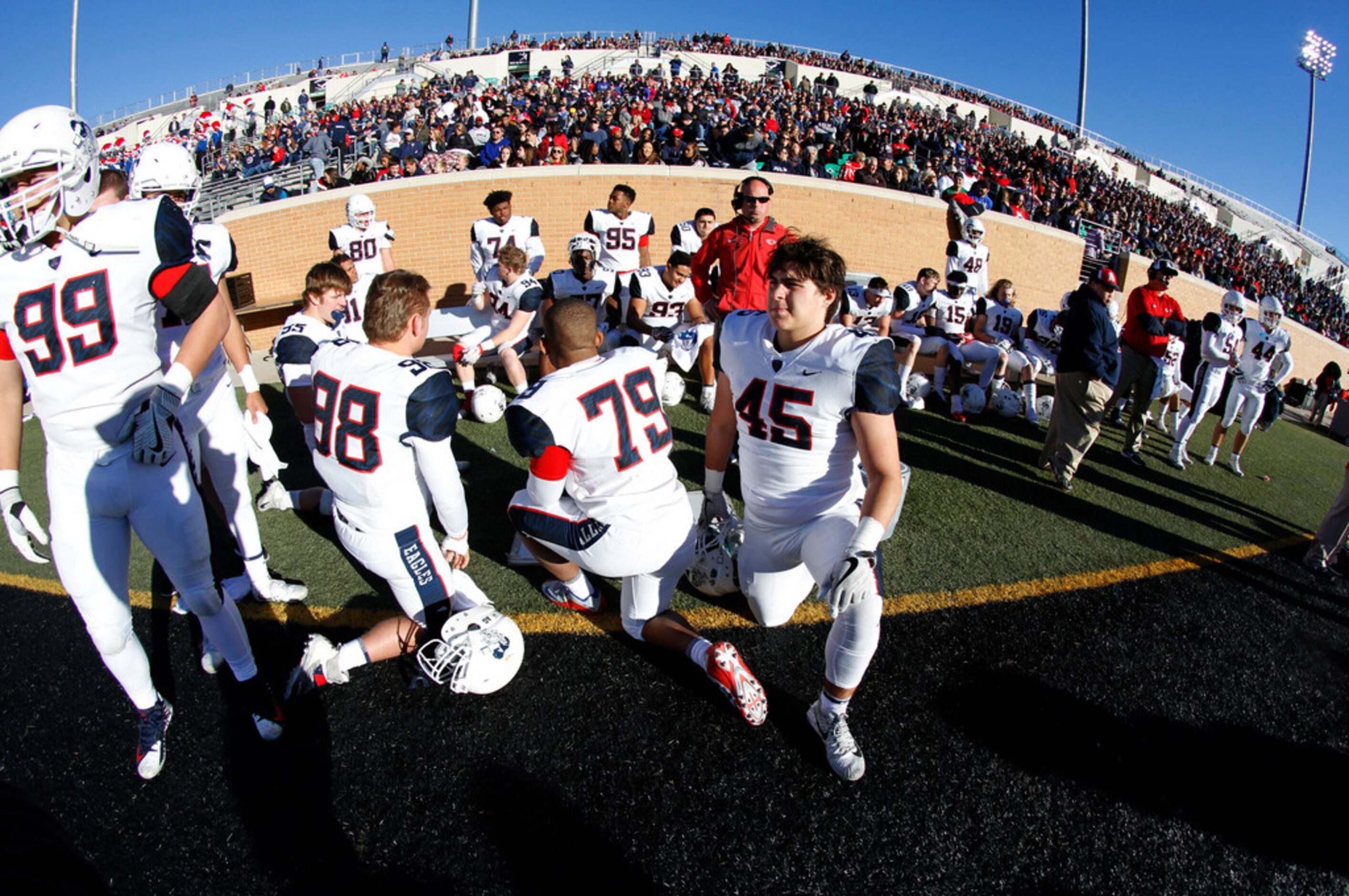 Members of the Allen Eagles take a break along the team bench area during fourth quarter...