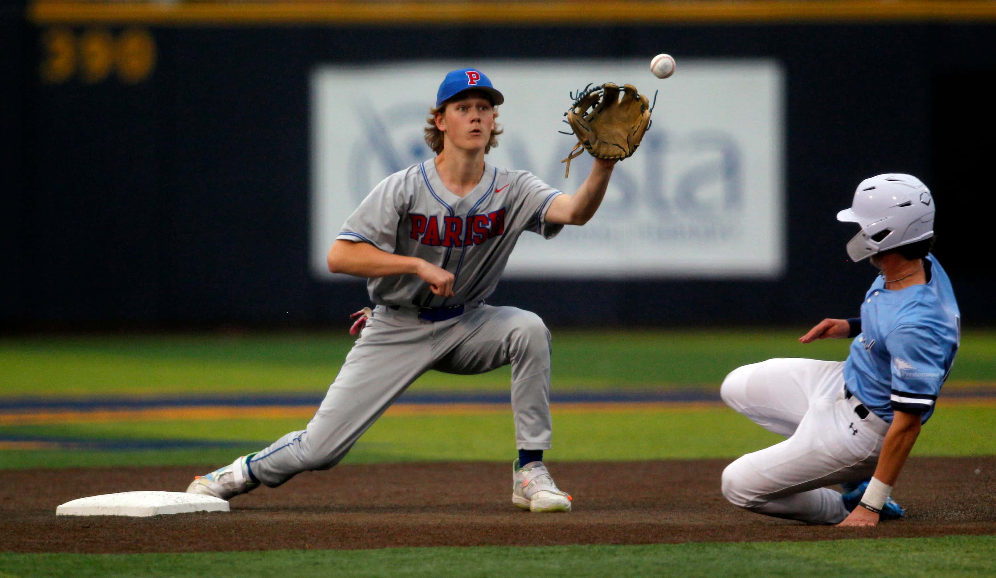 Parish Episcopal 2nd baseman Jackson D'Antoni (34), left, pulls in a throw from his catcher...