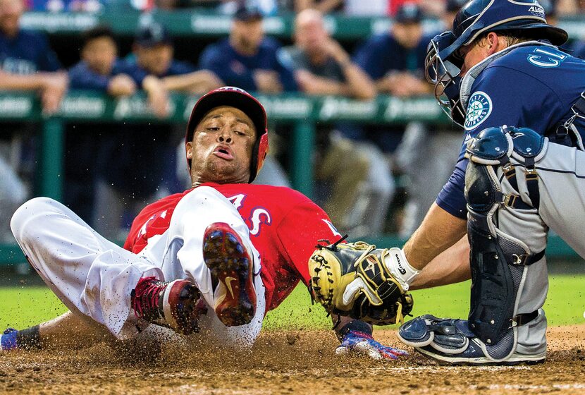 Texas Rangers third baseman Adrian Beltre was tagged out at home by Seattle Mariners catcher...