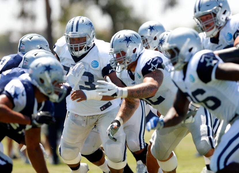 Dallas Cowboys center Joe Looney (73) and the left side of the line block the defense during...