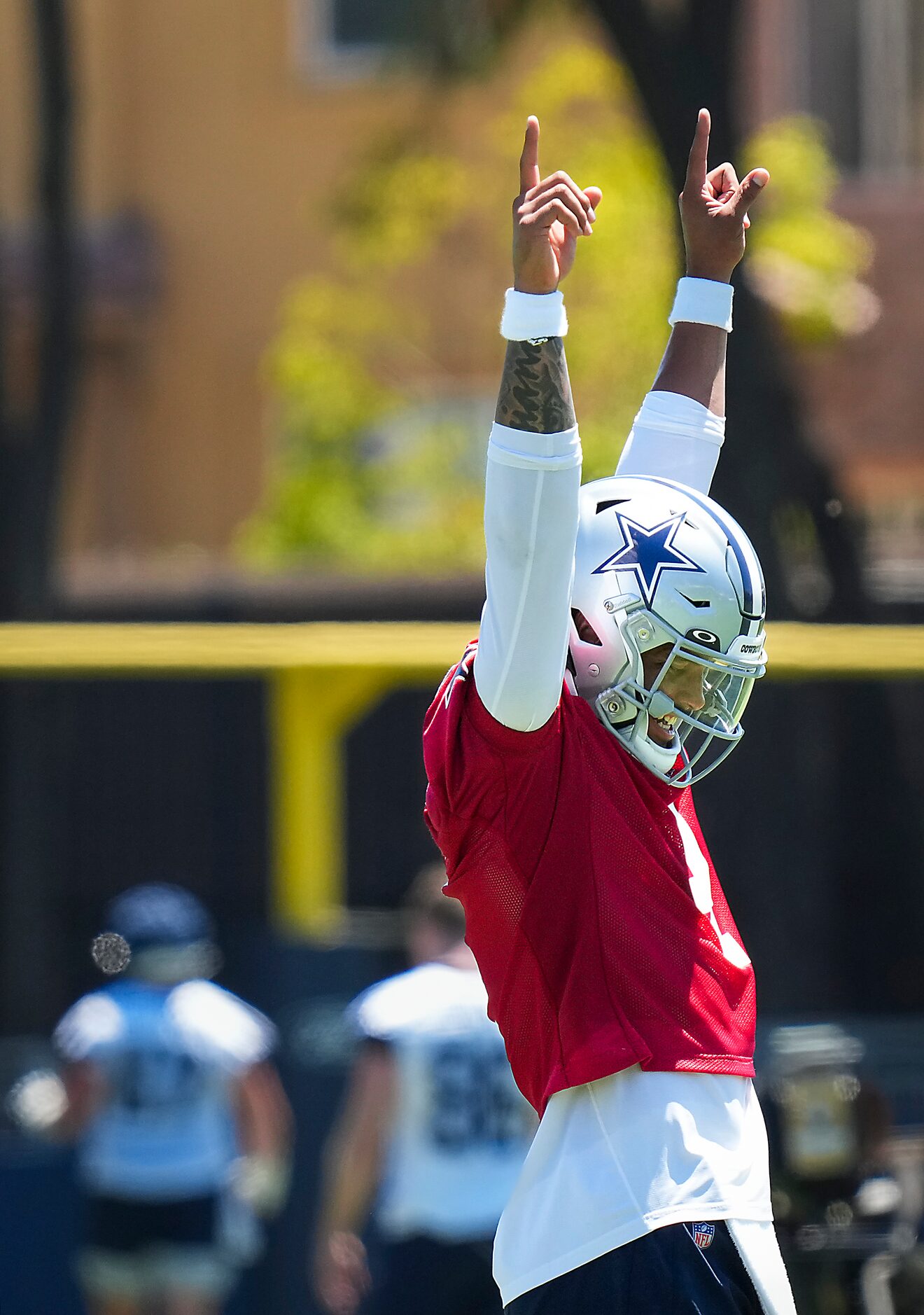 Dallas Cowboys quarterback Dak Prescott cheers a throw by teammate Will Grier during a...