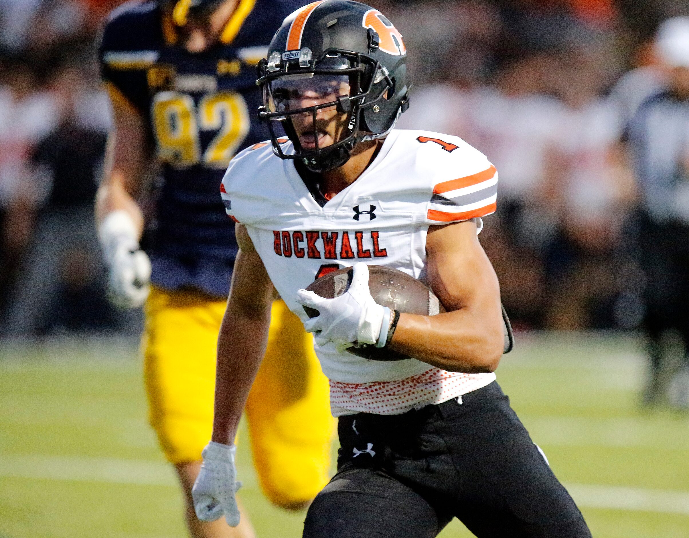 Rockwall High School wide receiver Aiden Meeks (1) carries the ball on a reverse for a...