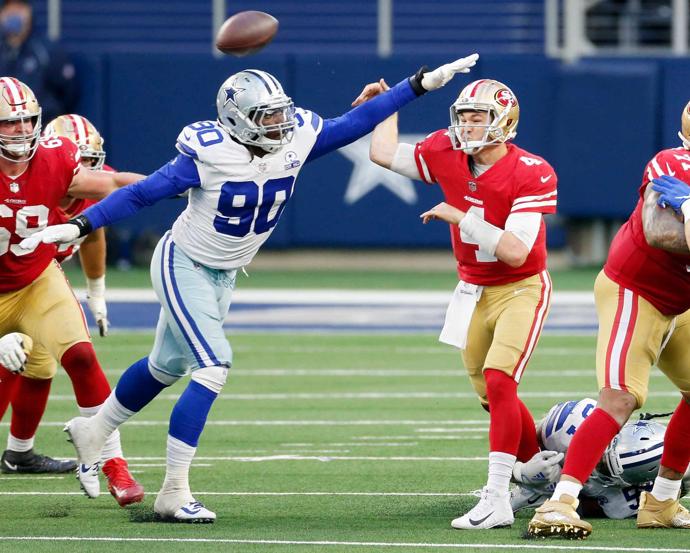 Dallas Cowboys defensive end DeMarcus Lawrence (90) disrupts a pass from San Francisco 49ers...