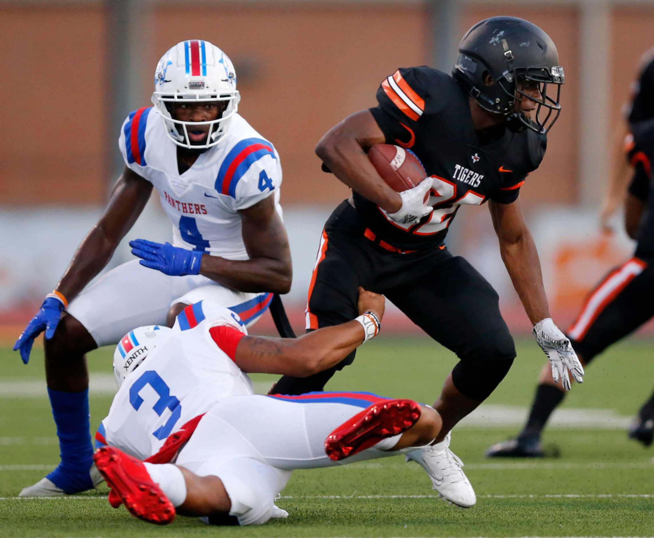 Duncanville quarterback Ja'Quinden Jackson (3) tries to tackle Lancaster defensive back...