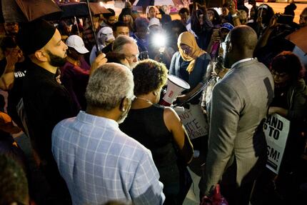 Pastor Michael W. Waters lead prayer following a Mothers Against Police Brutality...