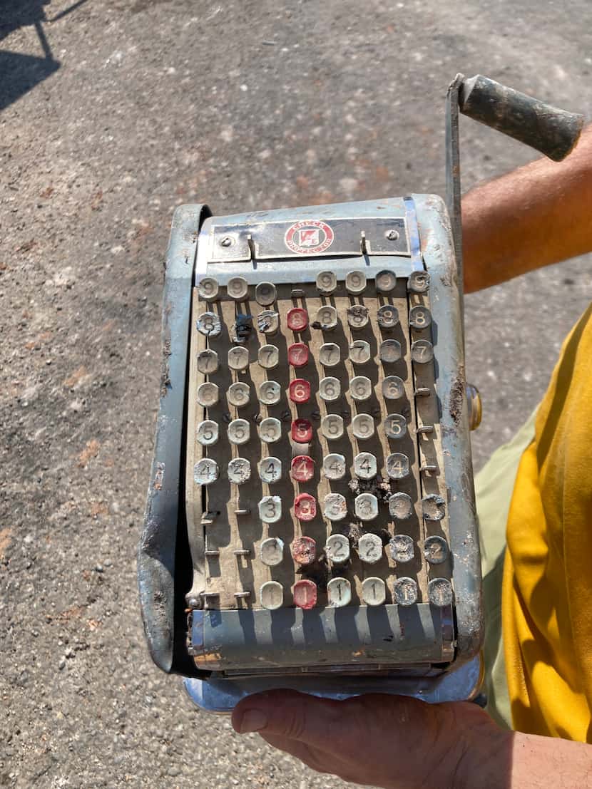 An old manual check machine pulled from the debris after the city of Melissa demolished...