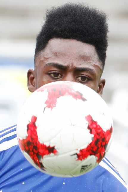 FC Dallas' Ronaldo Damus (18) gets a good look at the stitching of the ball as he follows...