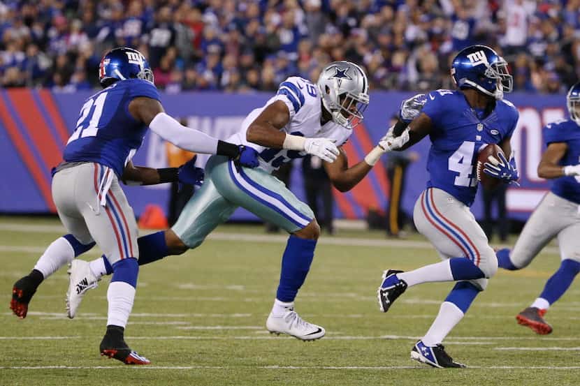 Dallas Cowboys wide receiver Brice Butler (19) attempts to tackle New York Giants cornerback...