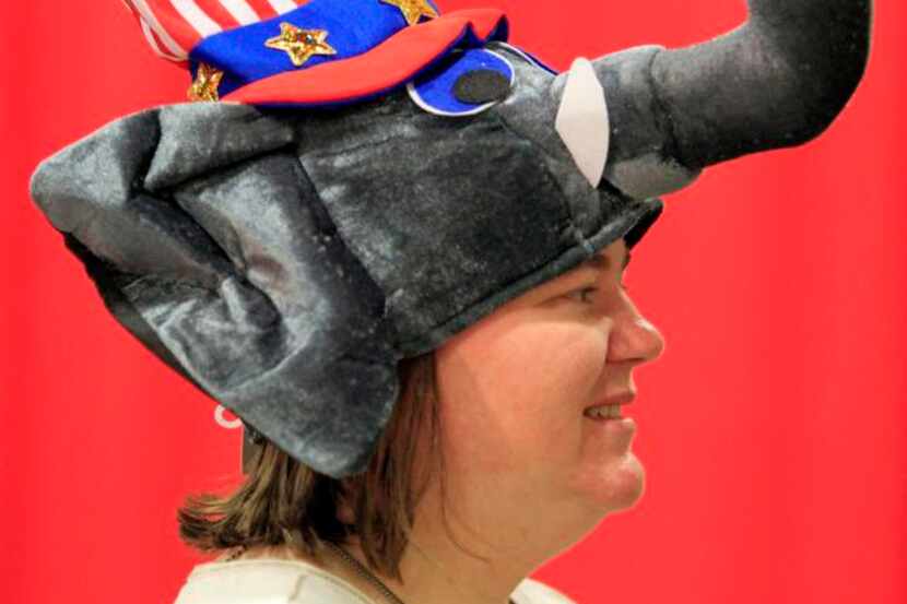 
Margaret Foland, a volunteer, sports a novelty hat before the state GOP convention starts...