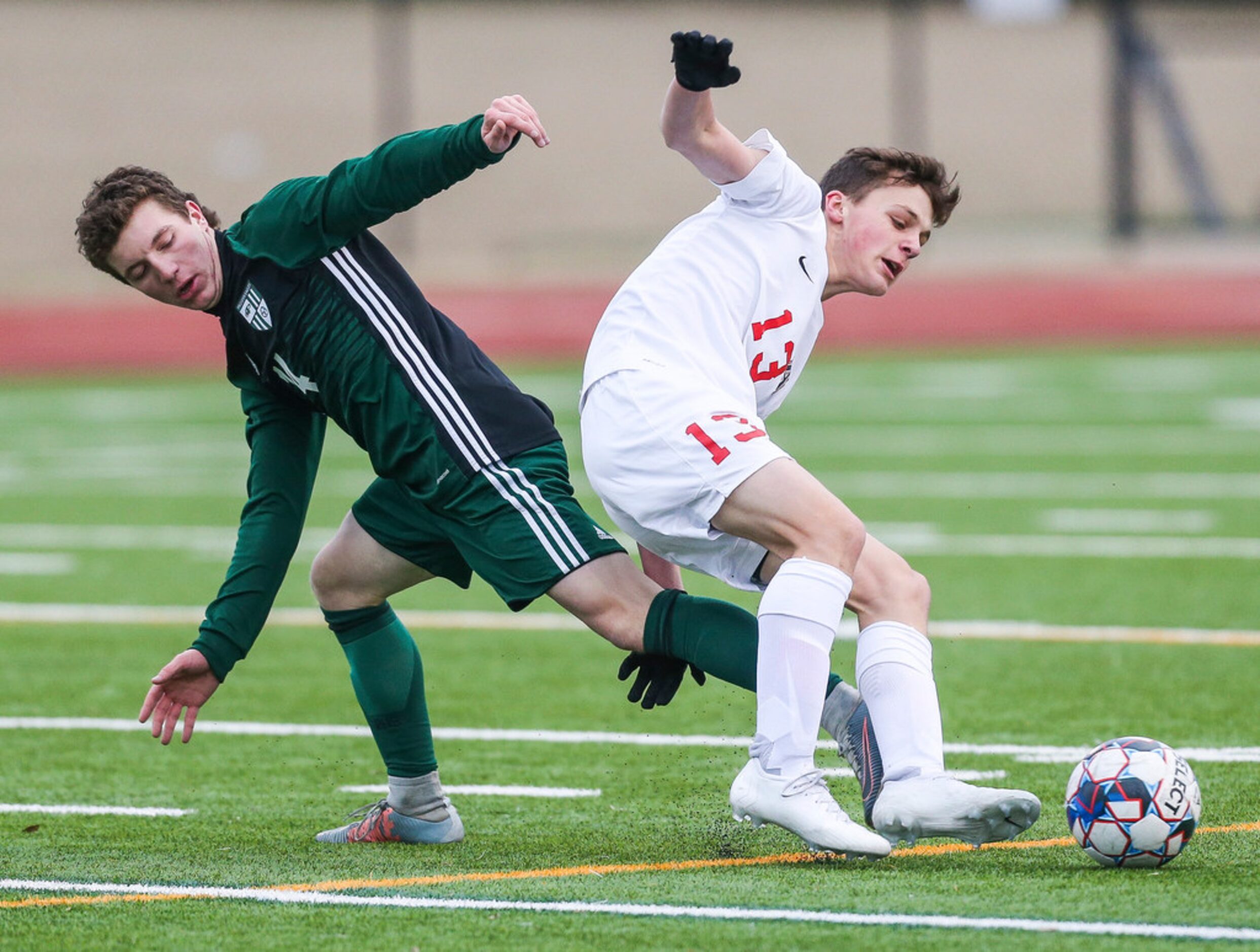 Prosper's Nolan DaRosa (14) and Allen's Benny Lube (13) battle for control of the ball...