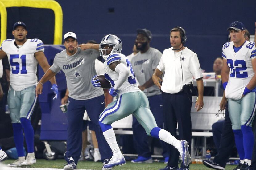 Dallas Cowboys cornerback Anthony Brown runs back an interception for a touchdown as Kyle...