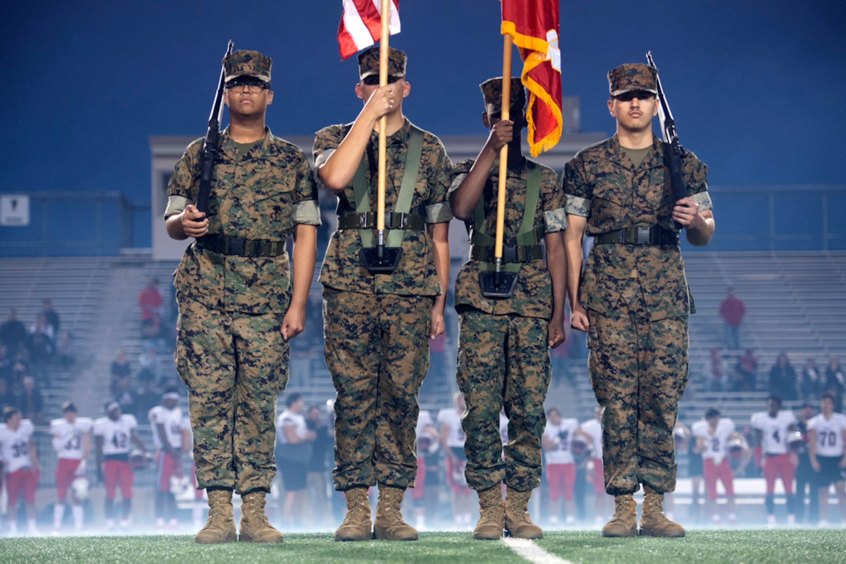 Irving High School junior ROTC members present the colors before a high school football game...