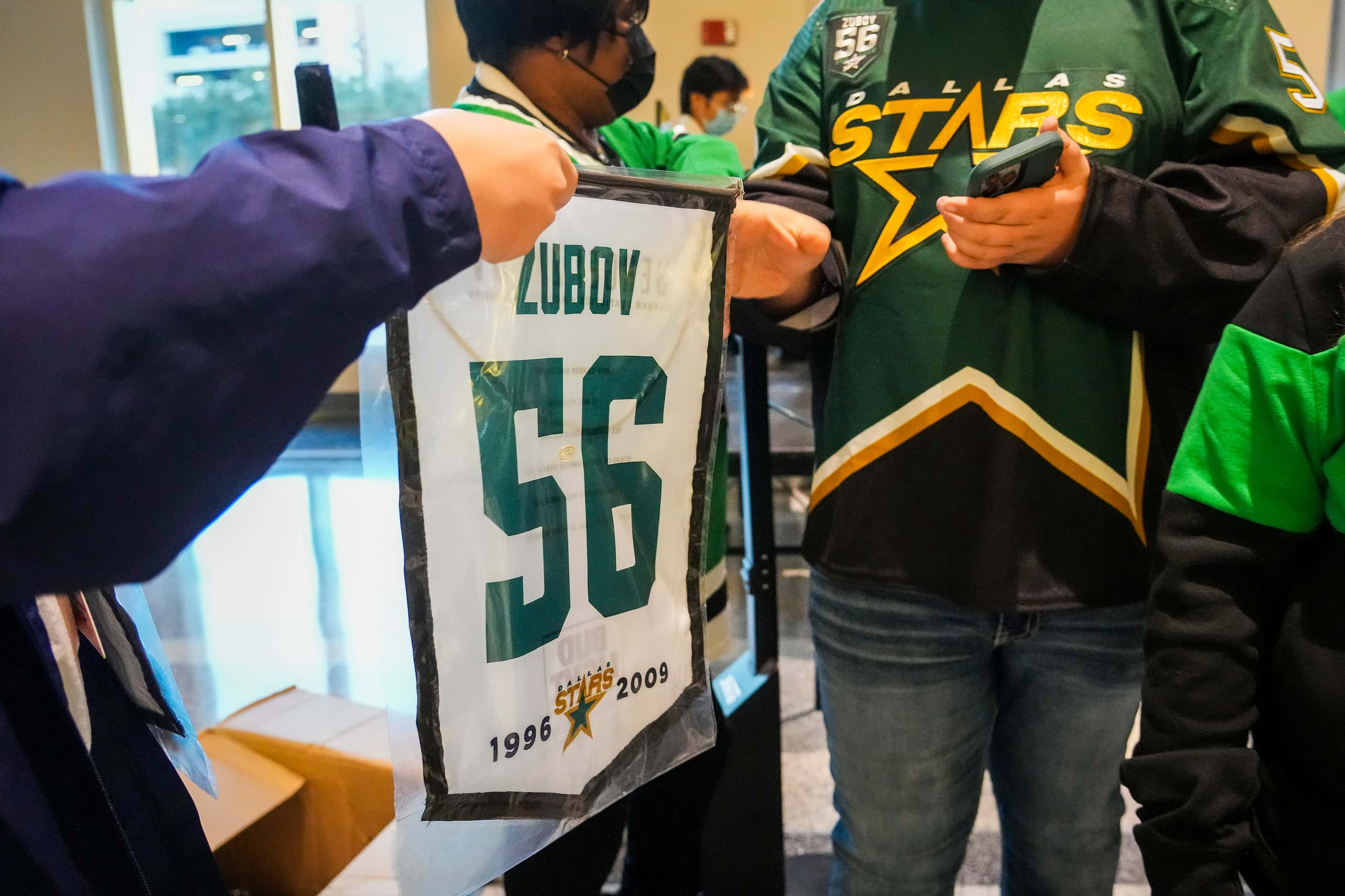 Banners honoring former Dallas Stars player Sergei Zubov given to fans as they arrive for...